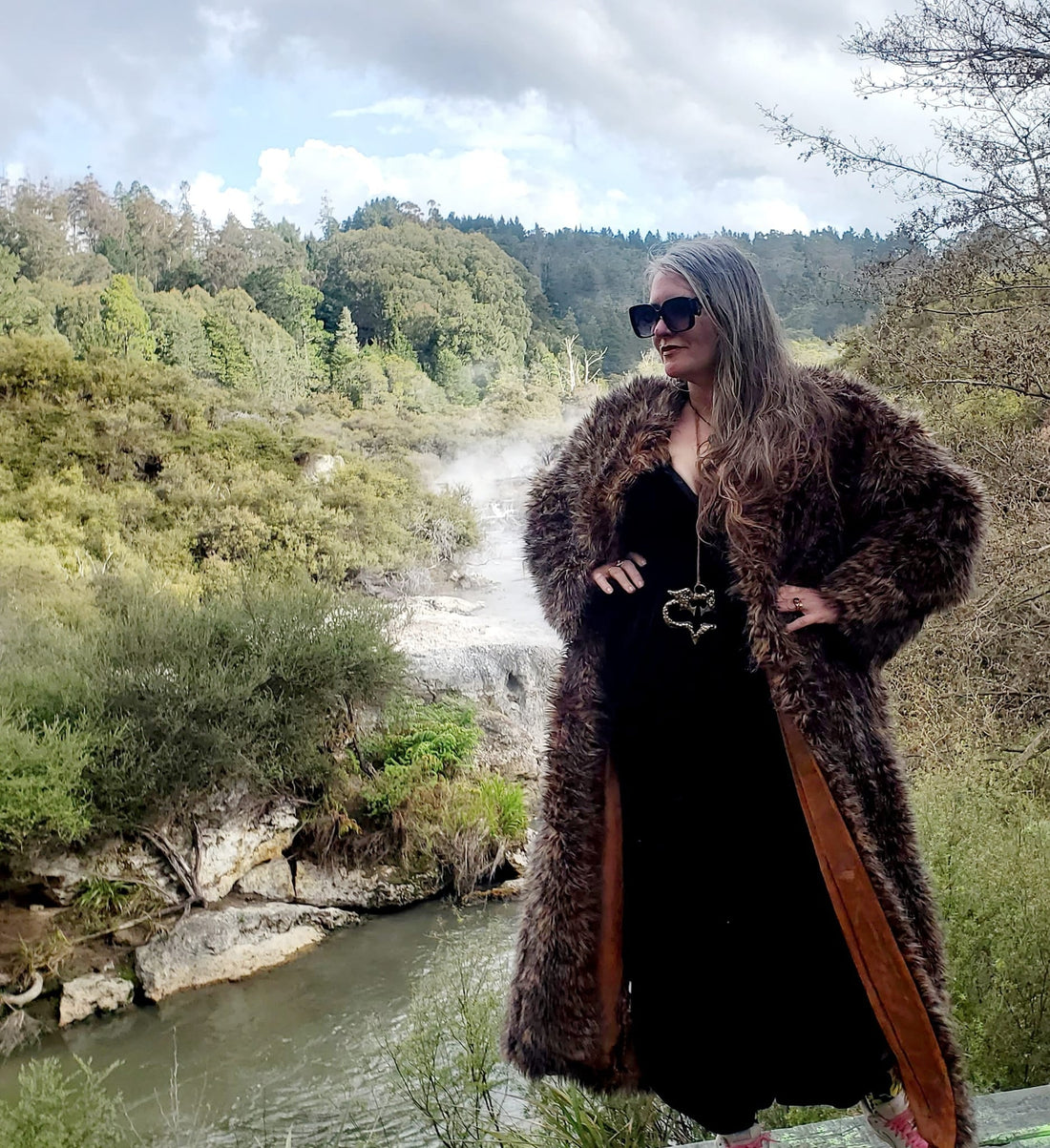 Rotorua Artist Karen Hansen stands against a geothermal backdrop in a creative rotorua scene